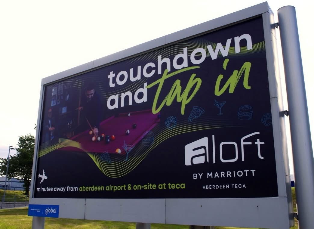 The installed Aloft airport banner seen from the approach road